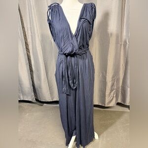 Navy blue knit jumpsuit with flowing cropped legs and tie shoulders